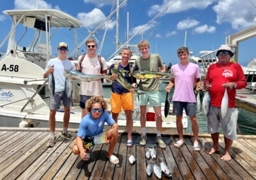 Group of friends enjoying a fishing trip on a boat in Aruba with Carla Charters